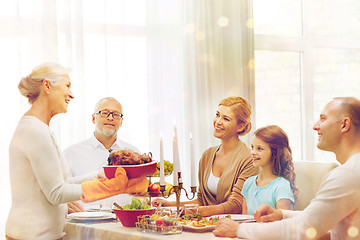 Image showing smiling family having holiday dinner at home