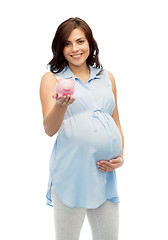 Image showing happy pregnant woman with piggybank