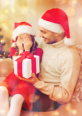 Image showing smiling daughter waiting for a present from father