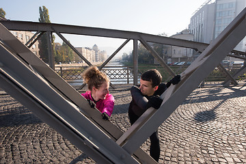 Image showing couple warming up before jogging