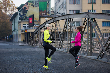 Image showing couple warming up before jogging