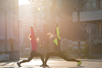 Image showing couple warming up before jogging