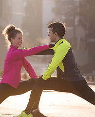 Image showing couple warming up before jogging