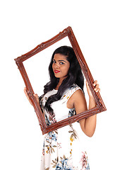 Image showing Woman looking trough frame.