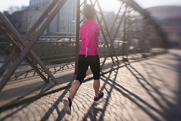 Image showing sporty woman jogging on morning