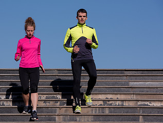 Image showing young  couple jogging on steps