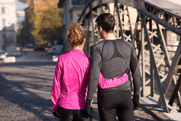 Image showing couple warming up before jogging