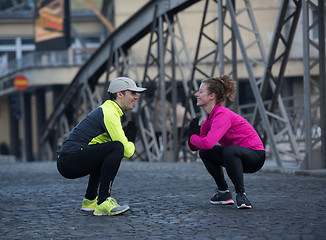 Image showing couple warming up before jogging