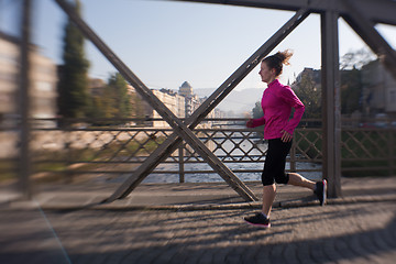 Image showing sporty woman jogging on morning