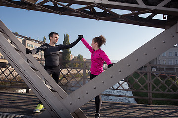 Image showing couple warming up before jogging