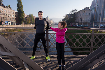 Image showing couple warming up before jogging