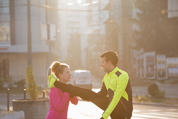 Image showing couple warming up before jogging