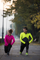 Image showing couple warming up before jogging