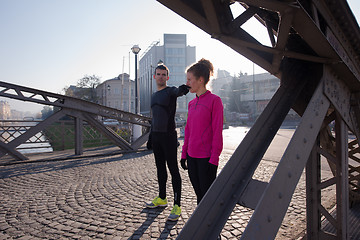 Image showing couple warming up before jogging