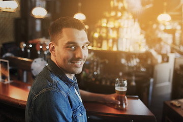 Image showing happy man drinking beer at bar or pub