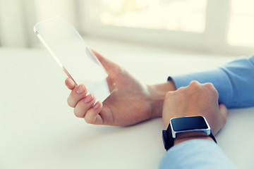 Image showing close up of hands with smart phone and watch