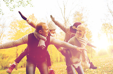 Image showing happy family having fun in autumn park