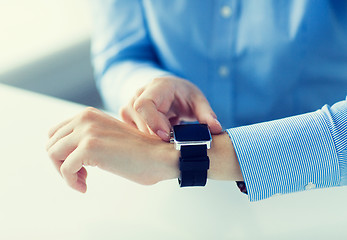 Image showing close up of hands setting smart watch