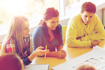 Image showing group of smiling students with blueprint