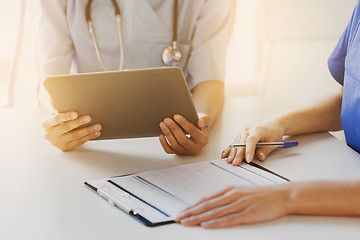 Image showing close up of doctors with tablet pc at hospital