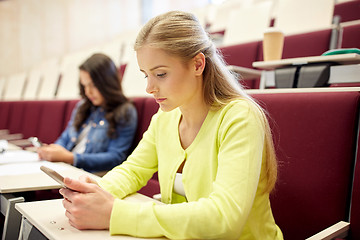 Image showing student girls with smartphones on lecture