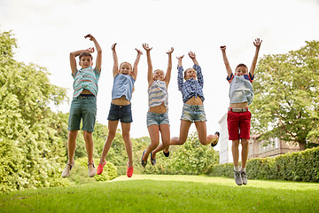 Image showing happy kids jumping and having fun in summer park