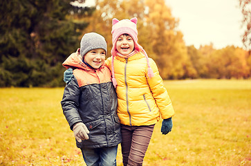Image showing happy little girl and boy in autumn park