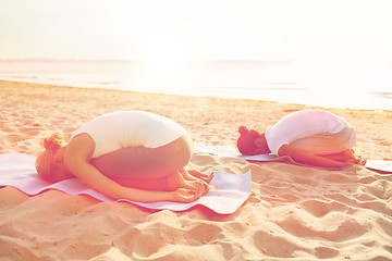 Image showing couple making yoga exercises outdoors