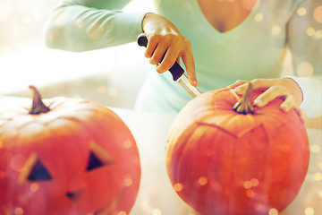 Image showing close up of woman with pumpkins at home