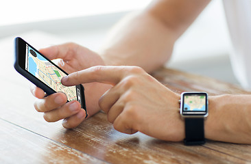 Image showing close up of hands with smart phone and watch