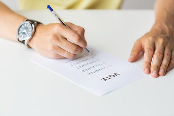 Image showing close up of hands with vote or ballot on election