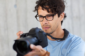 Image showing photographer with digital camera shooting in city