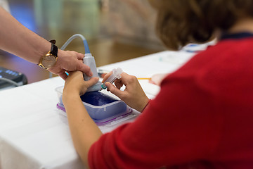 Image showing Medical doctor student learning to use ultra sound scanner machine.