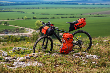 Image showing Bicycle with orange bags for travel