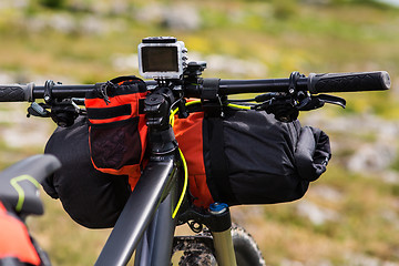 Image showing Bicycle with orange bags for travel