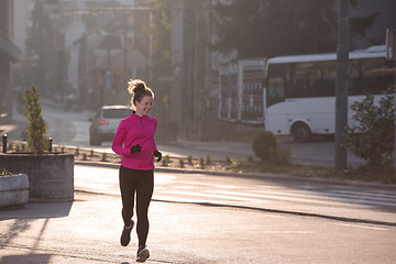 Image showing sporty woman jogging on morning