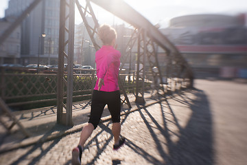 Image showing sporty woman jogging on morning