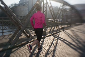 Image showing sporty woman jogging on morning