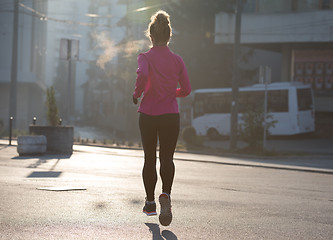 Image showing sporty woman jogging on morning