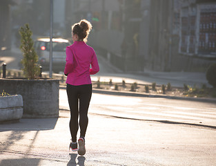 Image showing sporty woman jogging on morning