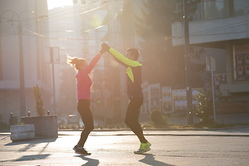 Image showing couple warming up before jogging