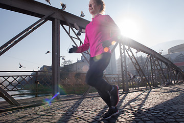 Image showing sporty woman jogging on morning