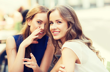 Image showing young women drinking coffee and talking at cafe