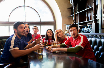 Image showing fans or friends watching football at sport bar