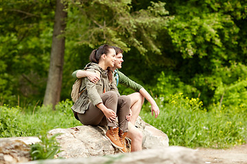 Image showing smiling couple with backpacks in nature