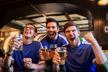 Image showing football fans or friends with beer at sport bar