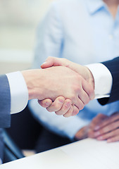 Image showing two businessmen shaking hands in office