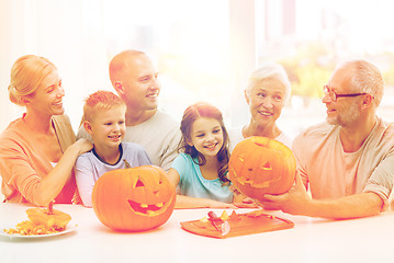 Image showing happy family sitting with pumpkins at home