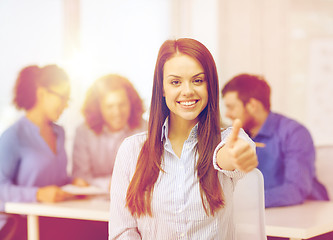 Image showing smiling young businesswoman showing thumbs up