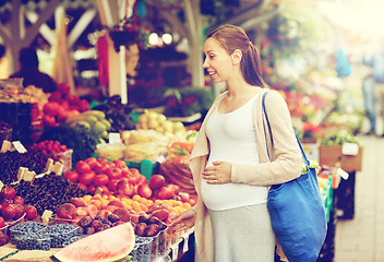 Image showing pregnant woman choosing food at street market